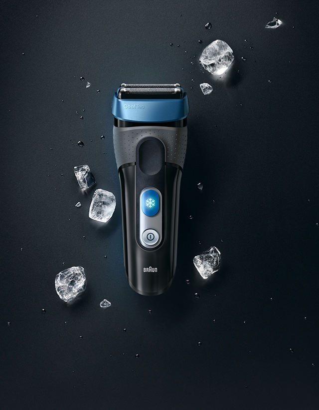 Black background with grey shaver and ice cubs around it