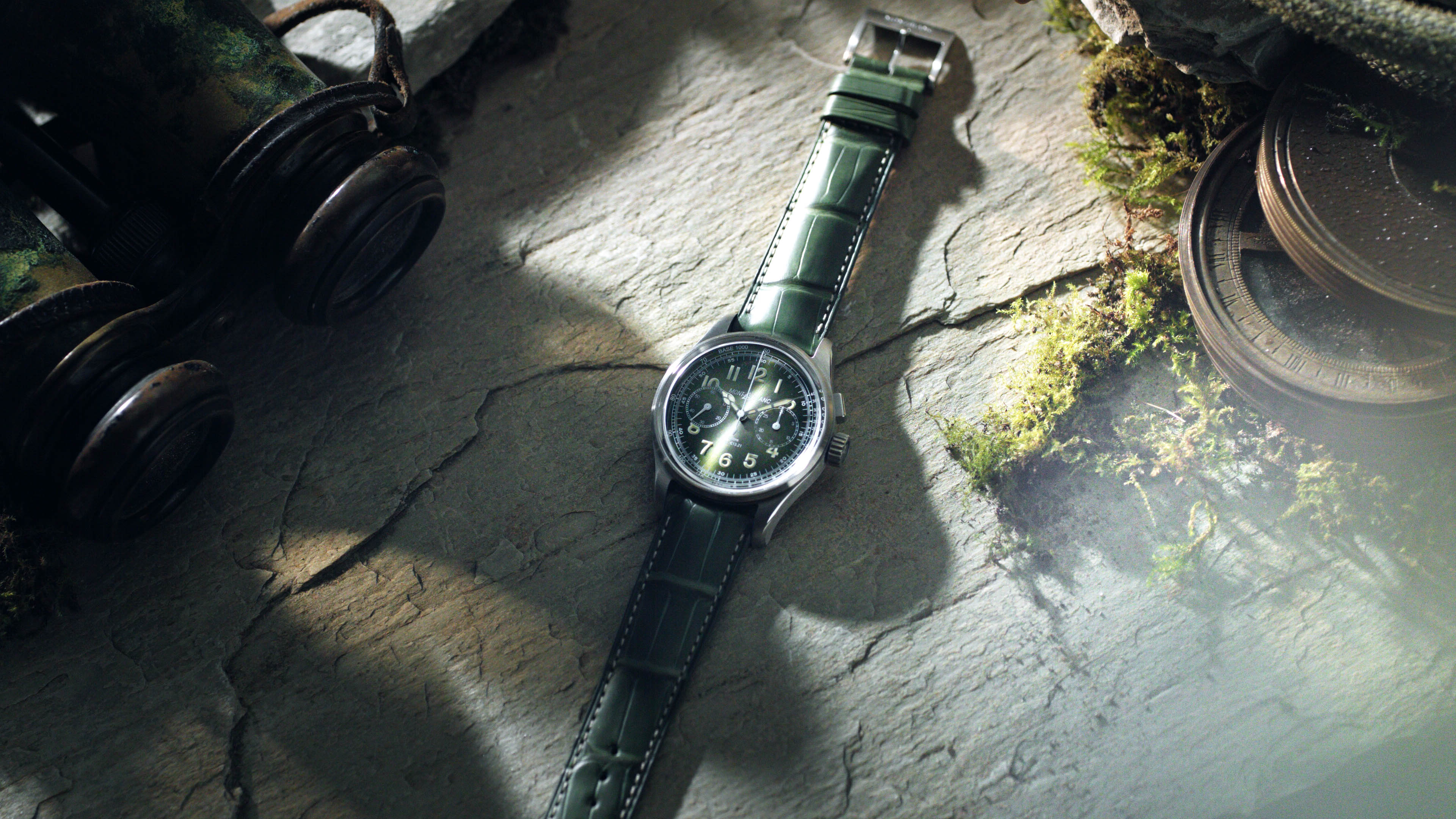 Watch with green strap band on a rock surface