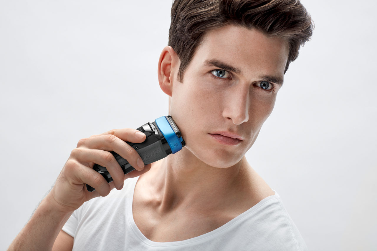 A man shaving his chin with white tshirt