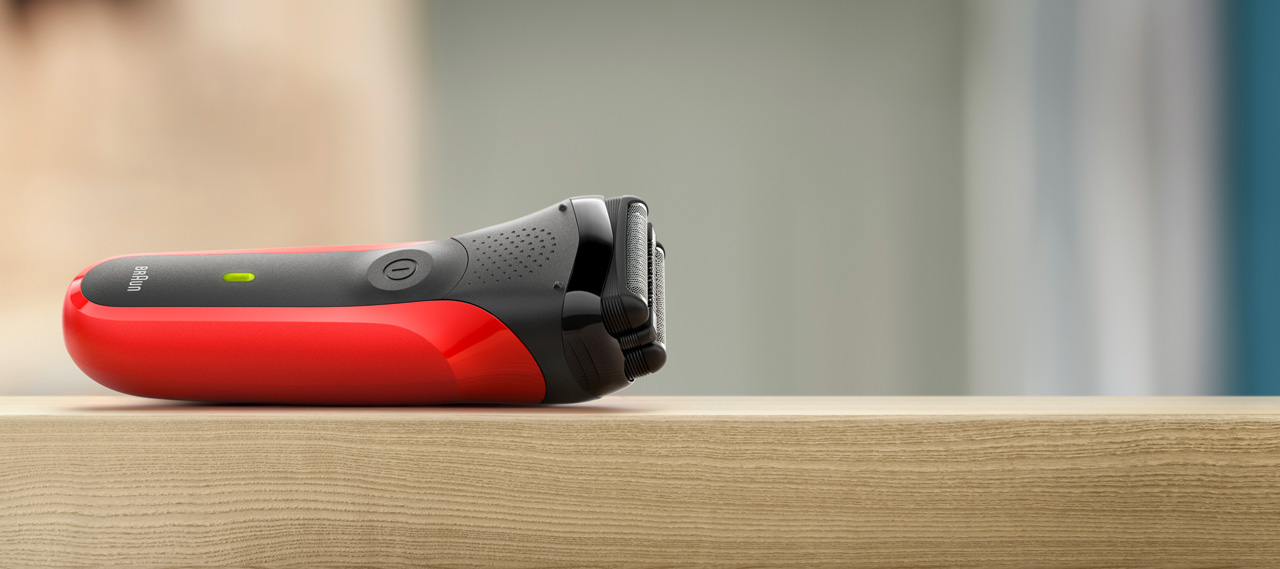 Red shaver on a wooden surface