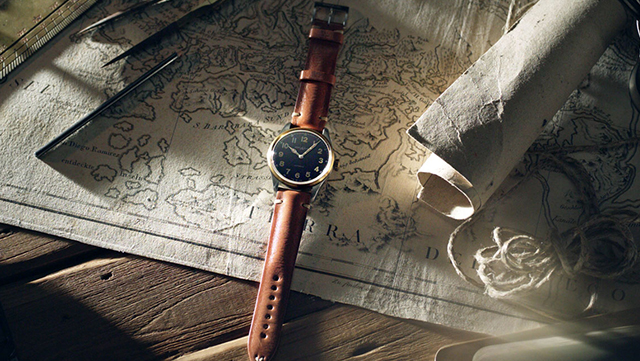 Brown watch on an old map